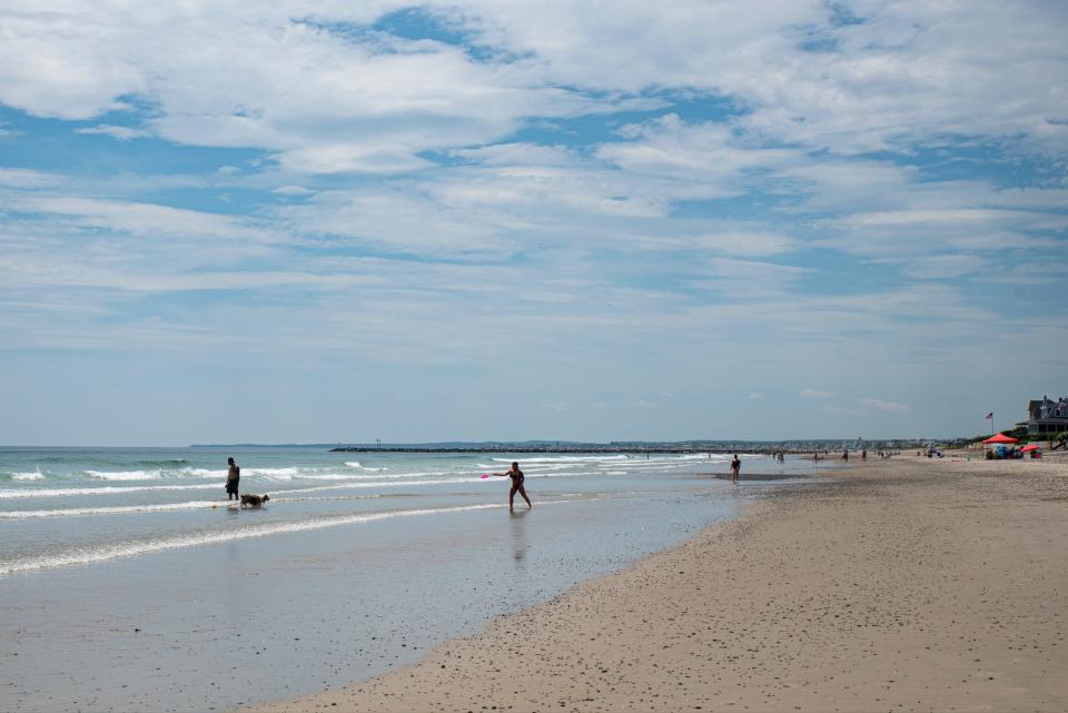 Beachgoers in Wells, Maine, enjoy the sand and sun Tuesday, June 8, 2021, a day after some people began reporting significant discoloration to their feet after leaving beaches up and down the York County coastline.