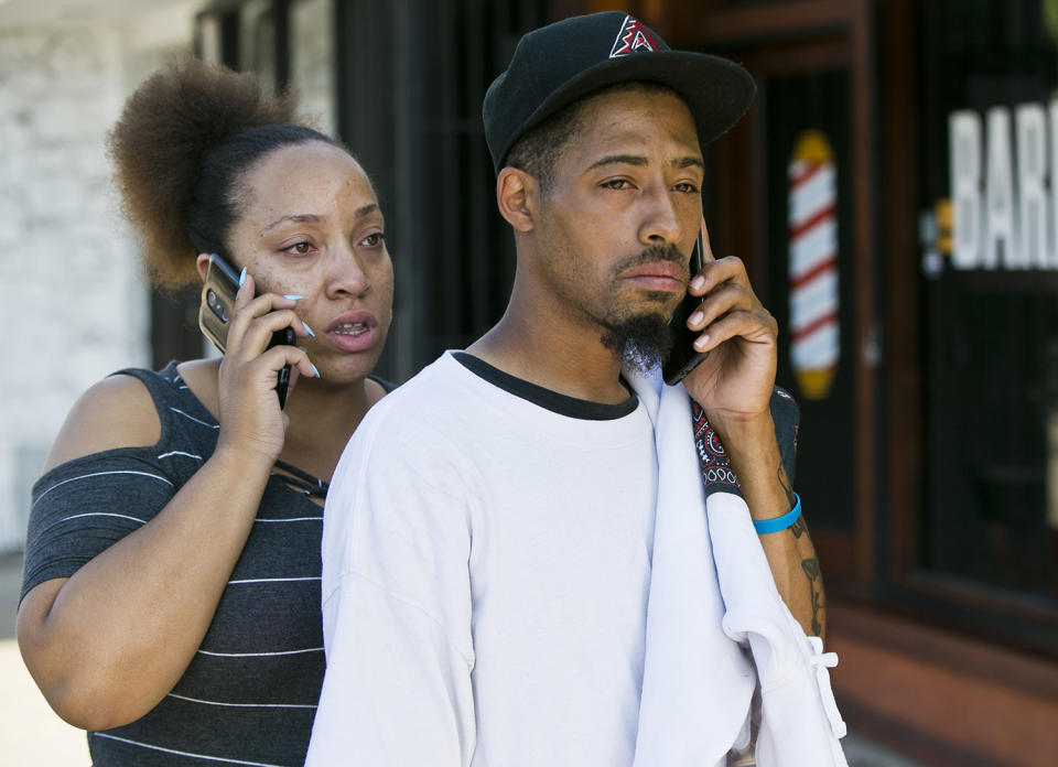 <p>Accident witness Courtney Crump, right, stands with his girlfriend Nicole Gotoy on the scene after Crump witnessed a van that plowed into a group of people dining on a Los Angeles sidewalk inuring several people on Sunday, July 30, 2017. Crumpm told The Associated Press the van jumped a curb and careened into a group of people eating outside The Fish Spot restaurant in the city’s Mid-Wilshire neighborhood. The cause of the crash is under investigation. (AP Photo/Damian Dovarganes) </p>