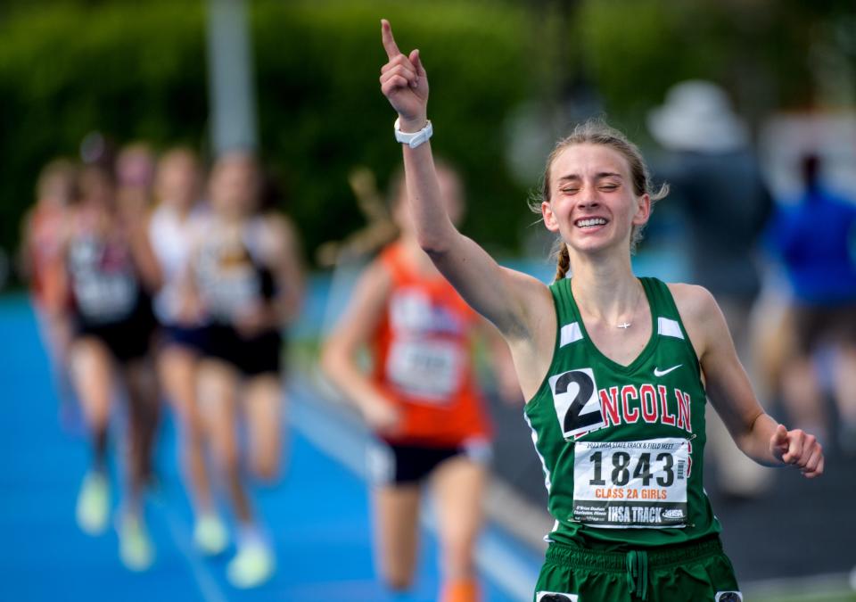 Lincoln's Becca Heitzig points to the sky as she crosses the finish line with a victory in the 800-meter run during the Class 2A State Track and Field Championships on Saturday, May 21, 2022 at Eastern Illinois University.