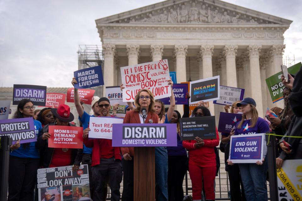 Former congresswoman Gabrielle Giffords speaks outside the US Supreme Court on 7 November during oral arguments in a case challenging federal law prohibiting domestic abusers from keeping firearms. (AP)