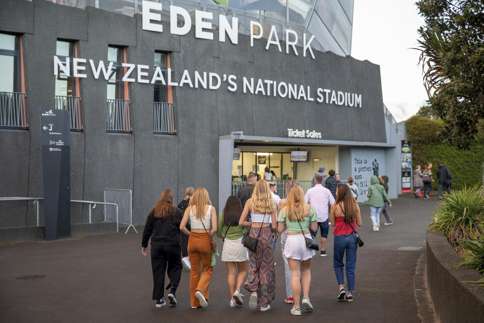 Fans arrive for Eden Park where New Zealand band Six60 is scheduled to perform in Auckland, New Zealand, Saturday, April 24, 2021. New Zealand band Six60 is being billed as the biggest live act in the world since the coronavirus pandemic struck after New Zealand stamped out the spread of the virus, allowing life to return to normal. On Saturday, the band will play a remarkable finale to their latest tour, performing in front of 50,000 people at the first-ever concert at Auckland’s Eden Park. (AP Photo/David Rowland)