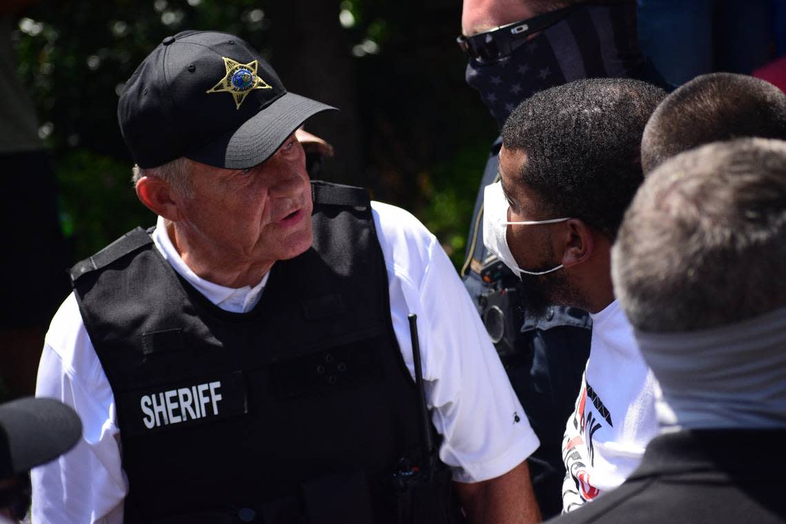 Alamance County Sheriff Terry Johnson speaks with Maurice Wells, a protester who he ordered arrested at the end of a march for racial justice in Graham on July 11, 2020. Wells had been ringing a bell in the town’s Court Square, angering counter-protesters, who asked the sheriff to make Wells leave.