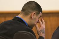 Former NFL player Aaron Hernandez touches his eye during his murder trial at the Bristol County Superior Court in Fall River, Massachusetts March 11, 2015. REUTERS/Dominick Reuter/Pool (UNITED STATES - Tags: CRIME LAW SPORT FOOTBALL)