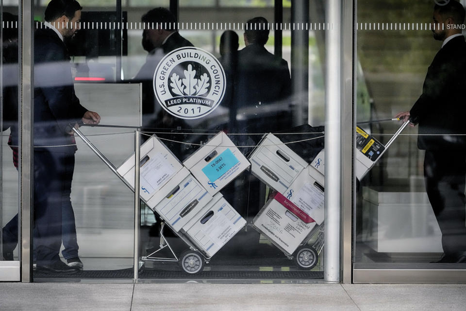 Case documents are wheeled into federal court Monday, June 17, 2024, in Los Angeles. NFL Commissioner Roger Goodell and Dallas Cowboys owner Jerry Jones, a longtime member of the league's broadcast committee, are expected to testify in a trial that could last up to three weeks. (AP Photo/Damian Dovarganes)