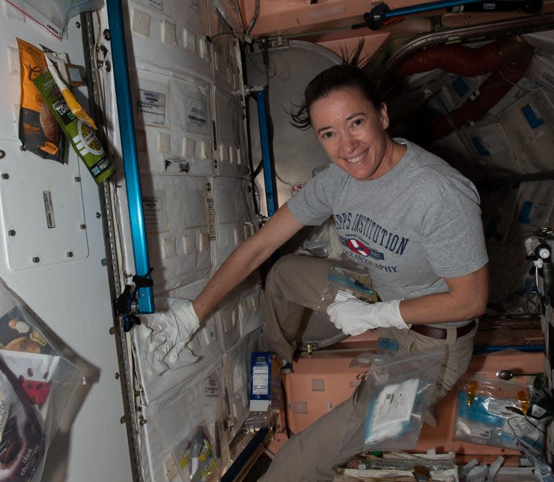 NASA astronaut and Expedition 65 Flight Engineer Megan McArthur collects a sample of microorganisms present on the International Space Station in July 2021 for analysis and tracking in the Microbial Tracking-3 study.