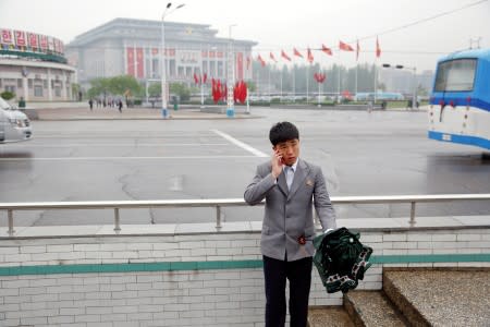 FILE PHOTO : A man speaks on the phone in front of the April 25 House of Culture, venue of the Workers' Party of Korea (WPK) congress in Pyongyang, North Korea