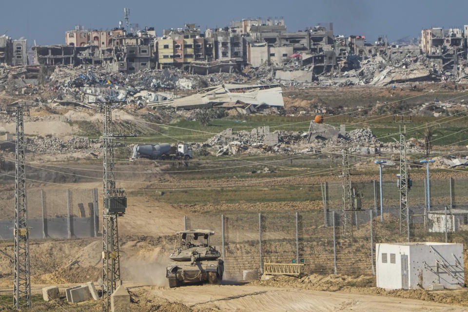 An Israeli tank maneuvers on the Gaza Strip border, in southern Israel, Friday, Dec. 29, 2023. The army is battling Palestinian militants across Gaza in the war ignited by Hamas' Oct. 7 attack into Israel. (AP Photo/Ariel Schalit)