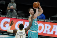 Charlotte Hornets forward Gordon Hayward shoots next to Dallas Mavericks forward Tim Hardaway Jr. during the first half of an NBA basketball game in Charlotte, N.C., Wednesday, Jan. 13, 2021. (AP Photo/Chris Carlson)