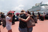 <p>Women hug as people line up to board a Royal Caribbean cruise ship that will take them to the U.S. mainland, in San Juan, Puerto Rico Sept. 28, 2017. (Photo: Alvin Baez/Reuters) </p>