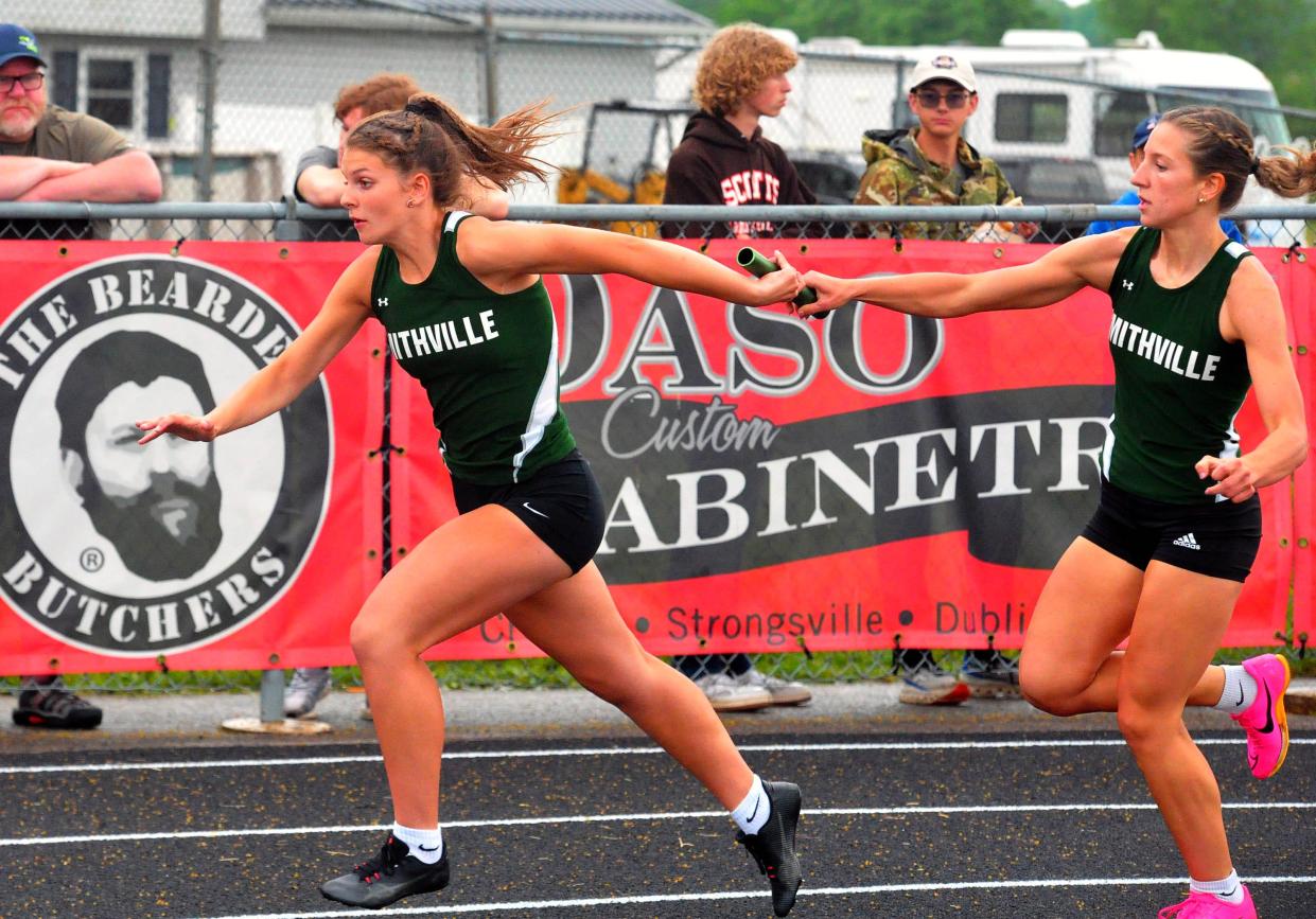 Smithville's Maddy Lengacher hands off to her sister Faith Lengacher for the final leg of the girls 4x200 meter relay.