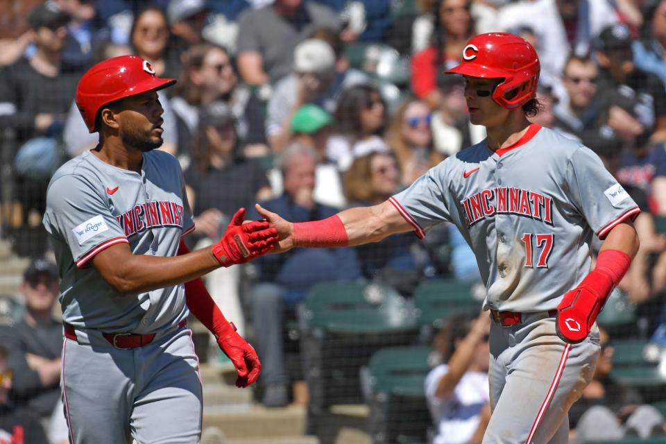 Third baseman Jeimer Candelario (left) and right fielder Stuart Fairchild (right) after both scored on Luke Maile's single to start the scoring in the Reds' five-run second inning.