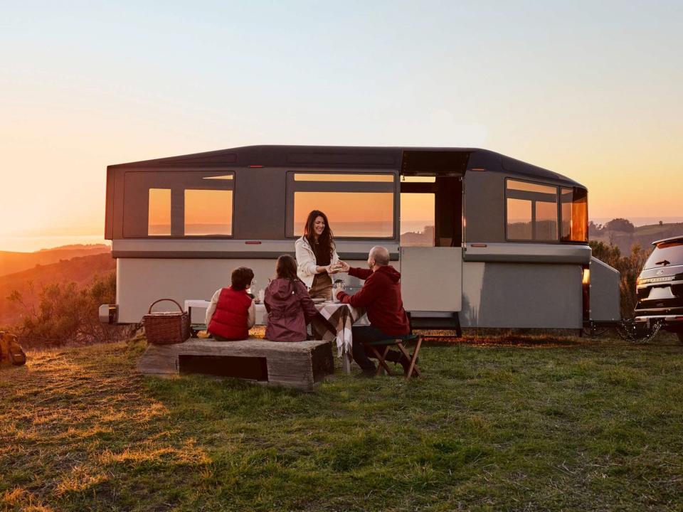 Lightship's electric L1 travel trailer outside by people.