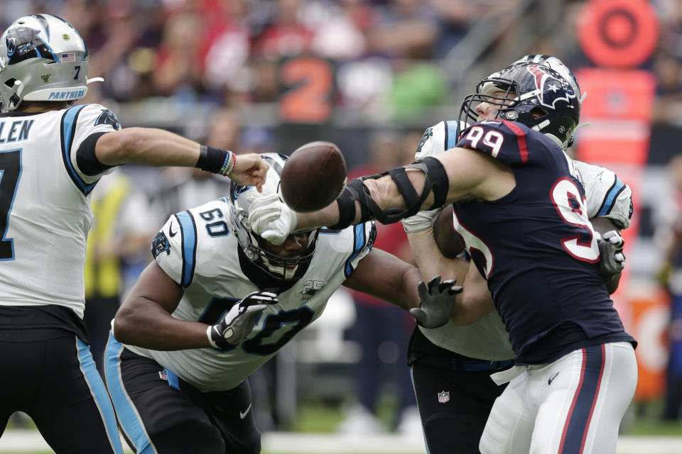 Houston Texans defensive end J.J. Watt (99) knocks the ball away from Carolina Panthers quarterback Kyle Allen (7) during the second half of an NFL football game Sunday, Sept. 29, 2019, in Houston. Watt recovered the fumble. (AP Photo/Michael Wyke)