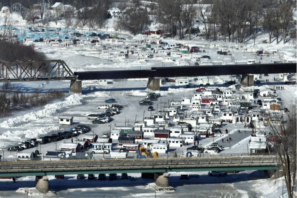 An overall view of some the more than 350 ice fishing cabins on the Ste-Anne river in Sainte-Anne-de-la-Pérade, Quebec on Sunday, January 15, 2023. The Sainte-Anne river is a tributary of the Saint-Lawrence River and it is known as the Tomcod capital of the world.