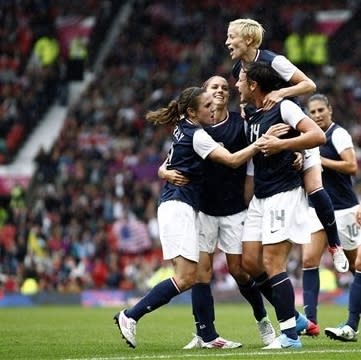 Day 4: United States' Abby Wambach, bottom center, celebrates with teammates including Megan Rapinoe, top, after scoring against North Korea during their group G women's soccer match at the London 2012 Summer Olympics, Tuesday, July 31, 2012 at Old Trafford Stadium in Manchester, England. (AP Photo)