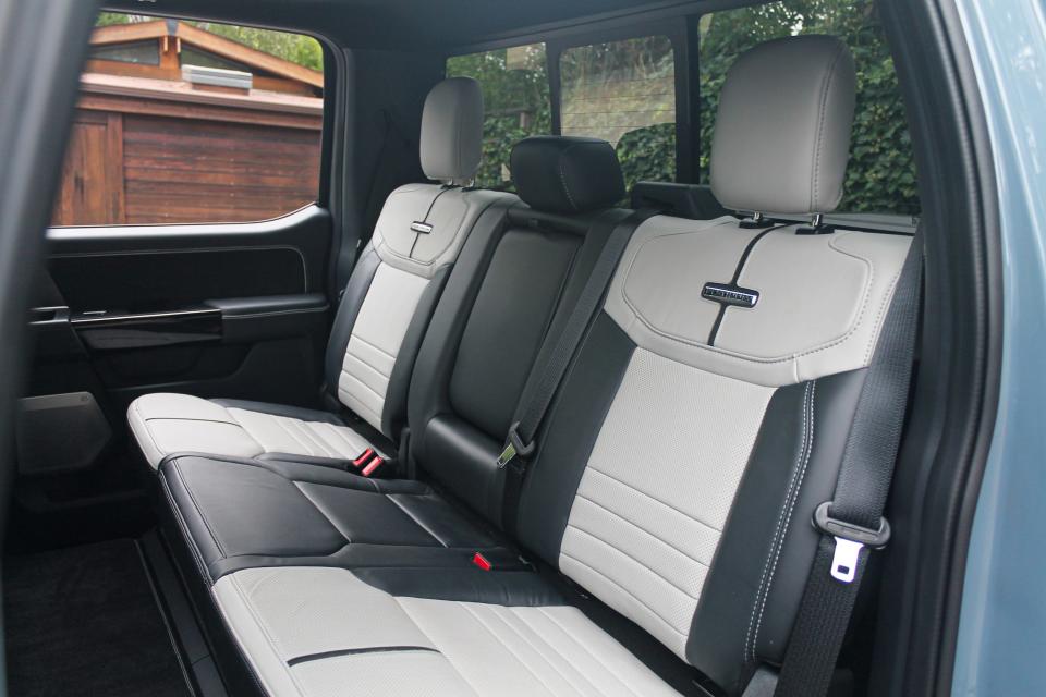 The white and black back seats of the 2023 Ford F-150 Lightning Platinum.