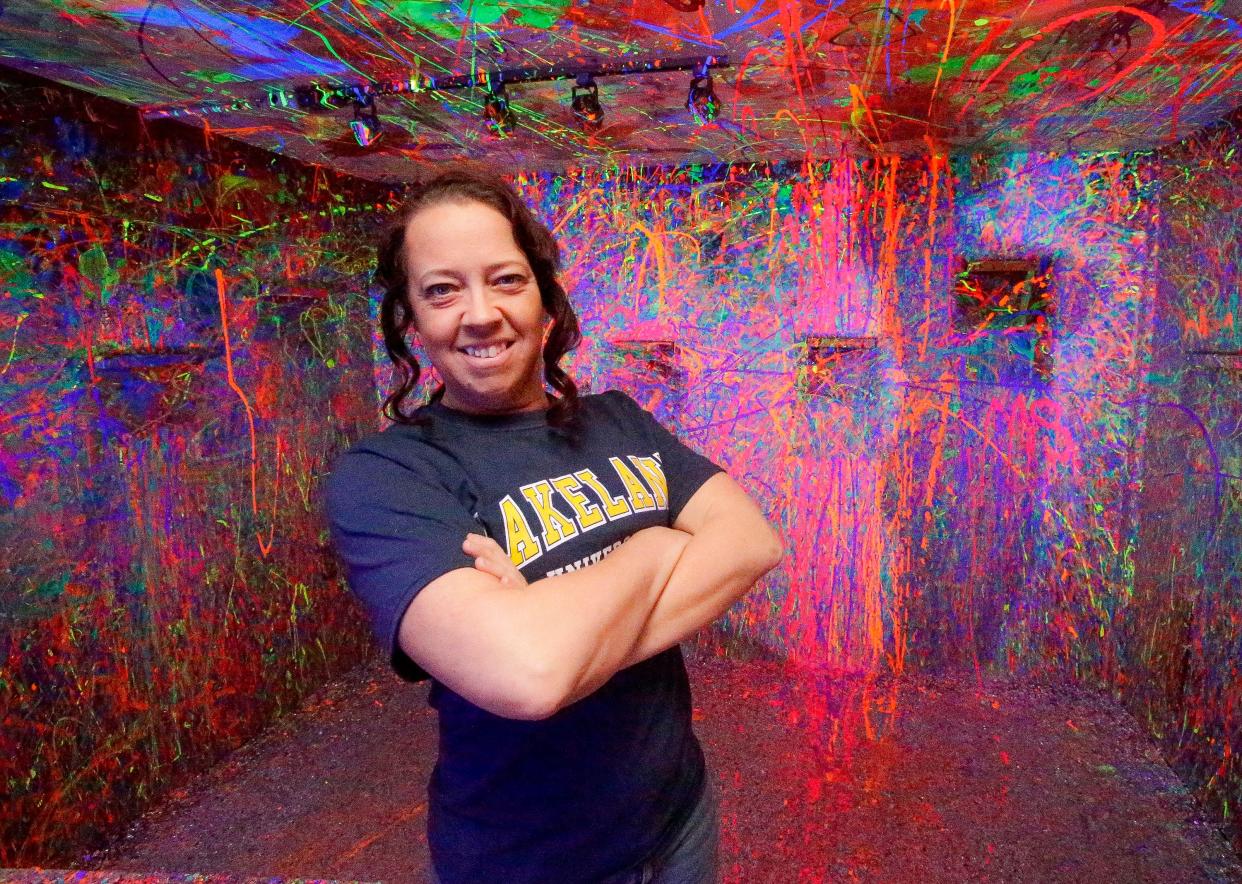 Ruff Rage Room’s Rebekah Hintzman poses in the splat room at the facility, Sunday, April 7, 2024, in Sheboygan, Wis.
