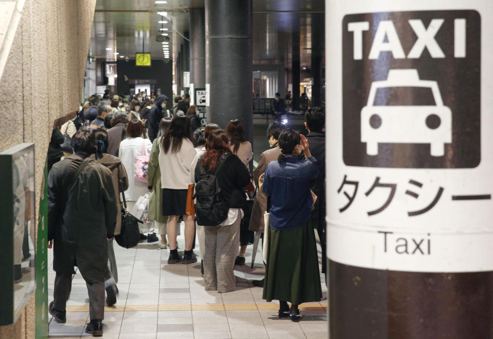 People queue up for taxi as train services are suspended following an earthquake in Sendai, Miyagi prefecture, Japan Saturday, March 20, 2021. A strong earthquake struck Saturday off northern Japan, shaking buildings even in Tokyo and triggering a tsunami advisory for a part of the northern coast. (Kyodo News via AP)