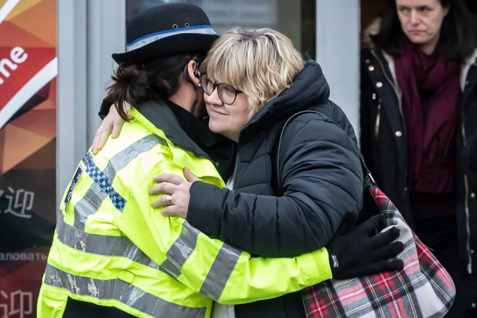 Lisa Squire, the mother of missing student Libby Squire, hugs a police officer on leaving a service at Hull Community Church. (PA)