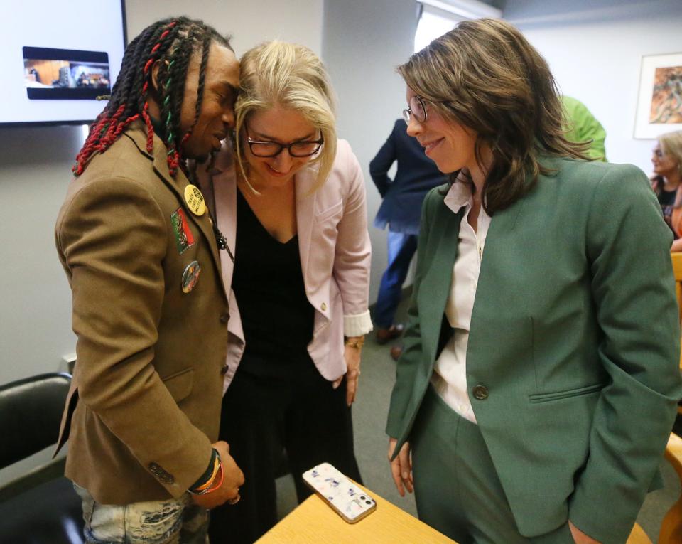 Out-of-state activist Michael Harris rejoices with defense attorneys Sarah Gelsomino, left, and Elizabeth Bonham, in February after being acquitted of charges related to the protests of Jayland Walker's shooting.