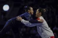 First place all around winner Morgan Hurd of the United States hugs third place winner Hitomi Hatakeda of Japan after the America Cup gymnastics competition Saturday, March 7, 2020, in Milwaukee. (AP Photo/Morry Gash)