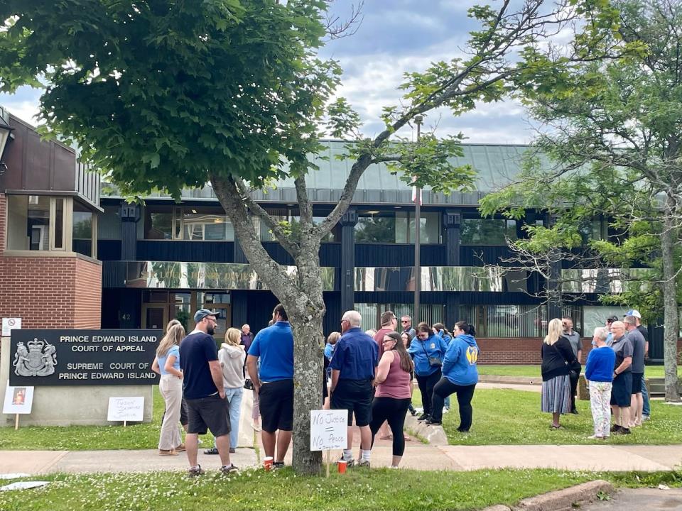 People crowd around the entrance to the court building in Charlottetown in advance of a court appearance Thursday by one of the two teens charged in the death of Tyson MacDonald. 