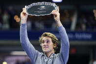 Casper Ruud, of Norway, holds up the runner-up trophy after losing to Carlos Alcaraz, of Spain, in the men's singles final of the U.S. Open tennis championships, Sunday, Sept. 11, 2022, in New York. (AP Photo/Matt Rourke)