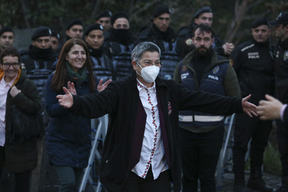 Turkish Medical Association President Dr. Sebnem Korur Fincanci gestures to friends and colleagues after being released from Bakirkoy women's prison in Istanbul, Turkey, Wednesday, Jan. 11, 2023. A court convicted Fincanci on Wednesday of disseminating "terror organization propaganda" to nearly three years in prison but also ruled to release her from pre-trial detention while she appeals the verdict. (AP Photo/Emrah Gurel)