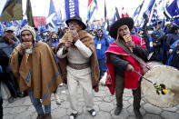 Supporters of Bolivian presidential candidate for the Movement Towards Socialism Party, MAS, Luis Arce, play pan flutes and drums during his closing campaign rally for the upcoming Oct. 18, presidential elections, in El Alto, Bolivia, Wednesday, Oct. 14, 2020. (AP Photo/Juan Karita)