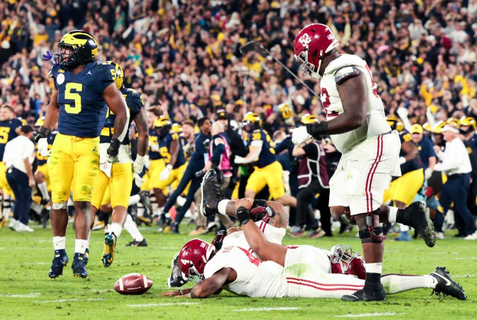 Michigan defensive end Josaiah Stewart celebrates after stopping a run by Alabama quarterback Jalen Milroe to seal a win