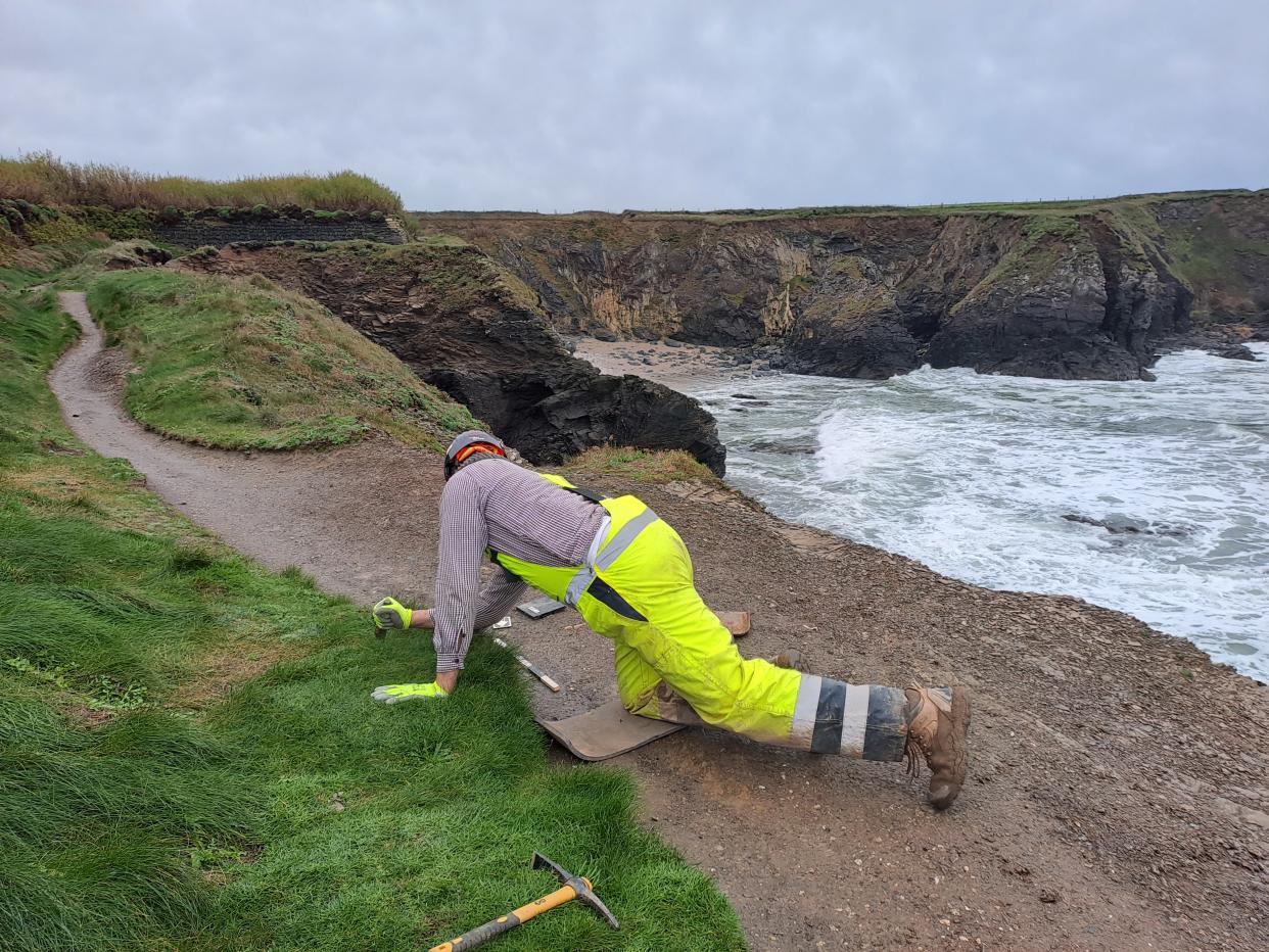 Richard Mikulski of the Cornwall archaeological unit excavates the site near Padstow (Cornwall Council/PA)