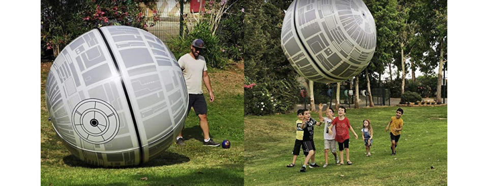 Kids playing with a large Death Star beach ball