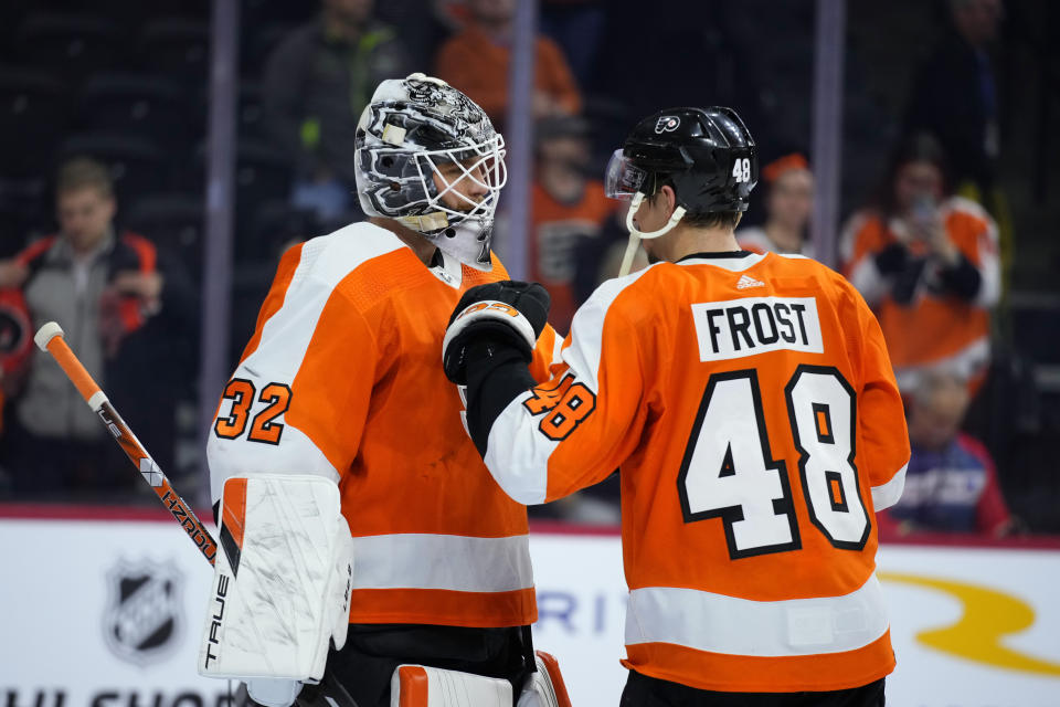 Philadelphia Flyers' Felix Sandstrom, left, and Philadelphia Flyers' Morgan Frost celebrate after an NHL hockey game, Tuesday, March 28, 2023, in Philadelphia. (AP Photo/Matt Slocum)