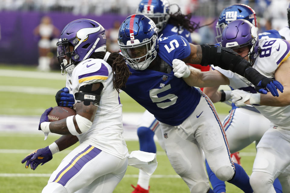 Minnesota Vikings running back Dalvin Cook runs from New York Giants defensive end Kayvon Thibodeaux (5) during the second half of an NFL football game, Saturday, Dec. 24, 2022, in Minneapolis. (AP Photo/Bruce Kluckhohn)