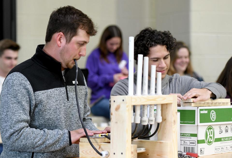 "Science, Sound and Music" students at the University of Mount Union, including junior Chance Coultrip, perform on their homemade musical instruments. Students played a snippet of the Nicki Minaj song, "Starships" in front of a small audience on campus.