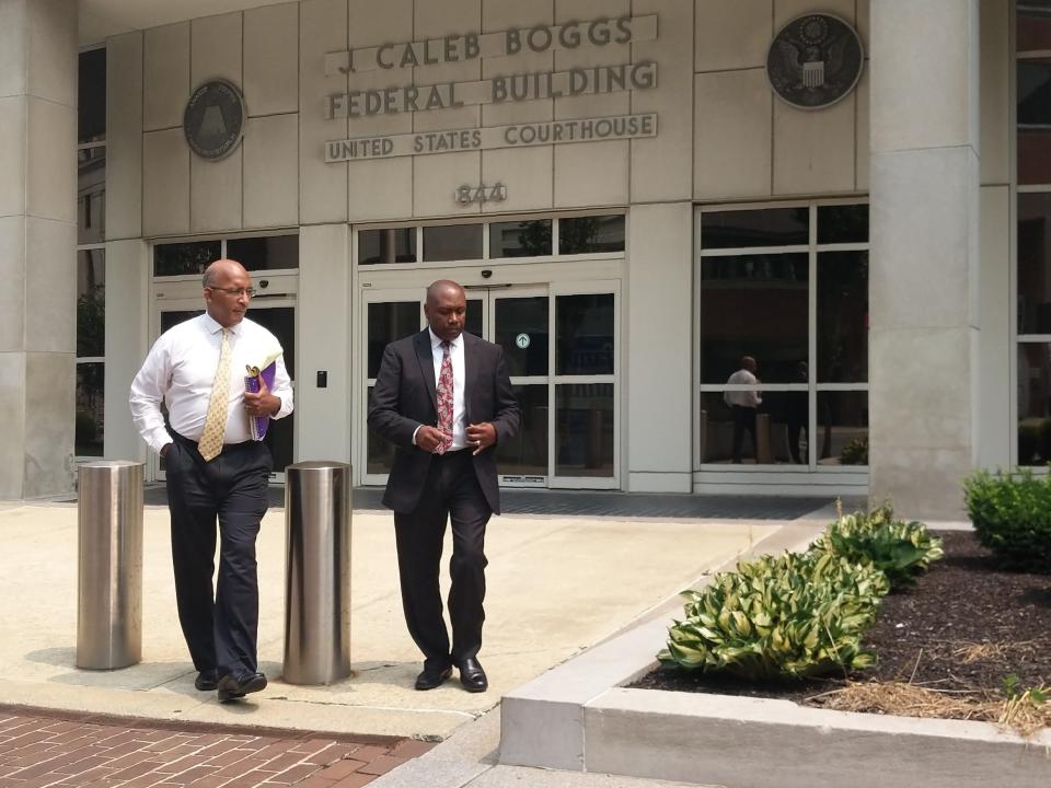 Patrick Titus, left, exits federal court in Wilmington last year.