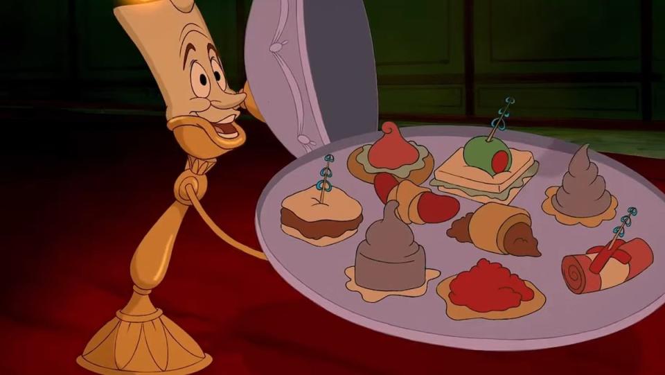 Lumiere holding a tray of finger foods during "Be Our Guest" in Beauty and the Beast
