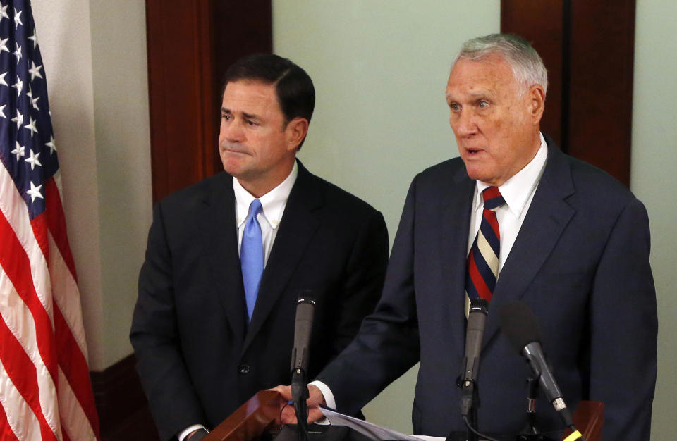 FILE - In this Sept. 4, 2018 file photo, Former Sen. Jon Kyl, R-Ariz., right, answers a question after Gov. Doug Ducey, R-Ariz., announced the appointment of the former senator to fill Sen. John McCain's seat in the U.S. Senate at a news conference at the Arizona Capitol in Phoenix. Ducey said Friday, Dec. 14, 2018 that Kyl will resign at the end of the year from the U.S. Senate seat. (AP Photo/Ross D. Franklin, File)