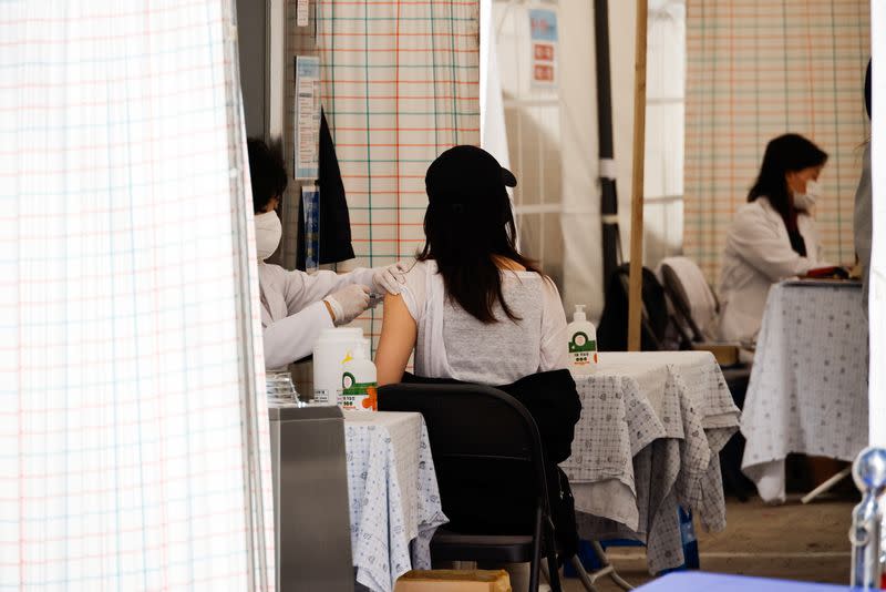 A woman gets an influenza vaccine at a hospital in Seoul