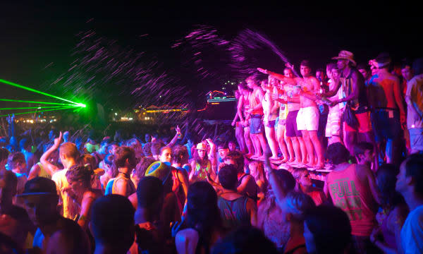 People dancing at the Full Moon Party on Haad Rin beach Koh Phangan Thailand