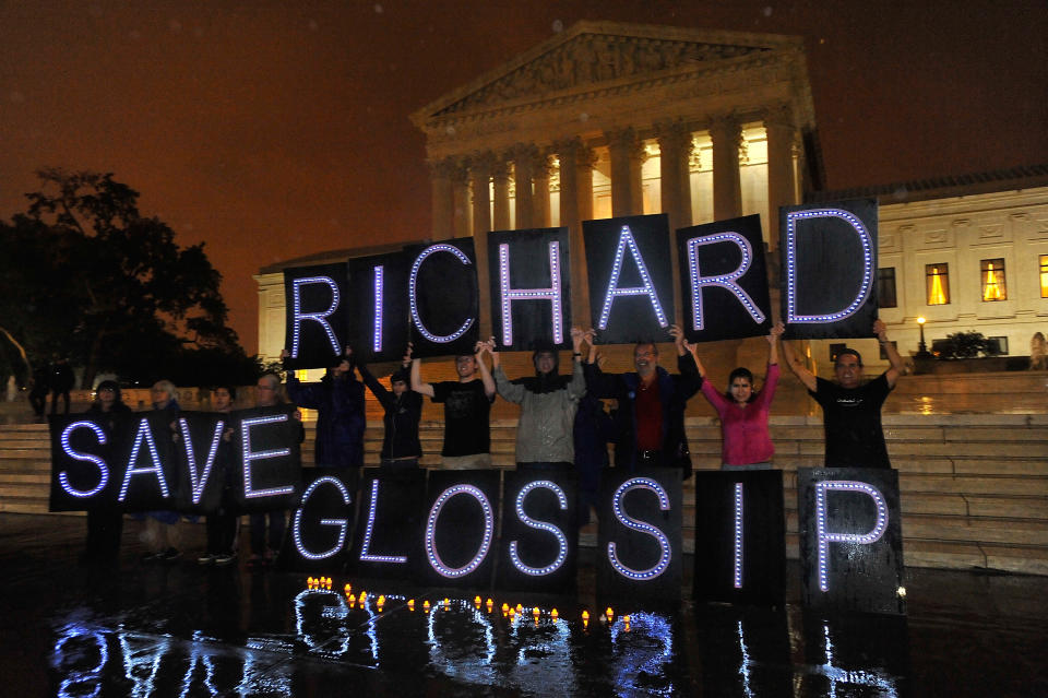 Protesters stand in front of the U.S. Supreme Court building holding signs that read Save Richard Glossip.