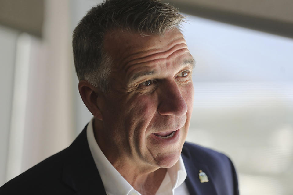 Vermont Gov. Phil Scott to a reporter before a news conference launching a Outdoors Recreation Initiative Wednesday, July 24, 2019, in Salt Lake City. Governors from about 25 states are gathering in Utah this week for the summer conference of the National Governors Association. The state leaders are expected to discuss infrastructure, cybersecurity and health care at the three-day conference in Salt Lake City that runs Wednesday through Friday. (AP Photo/Rick Bowmer)