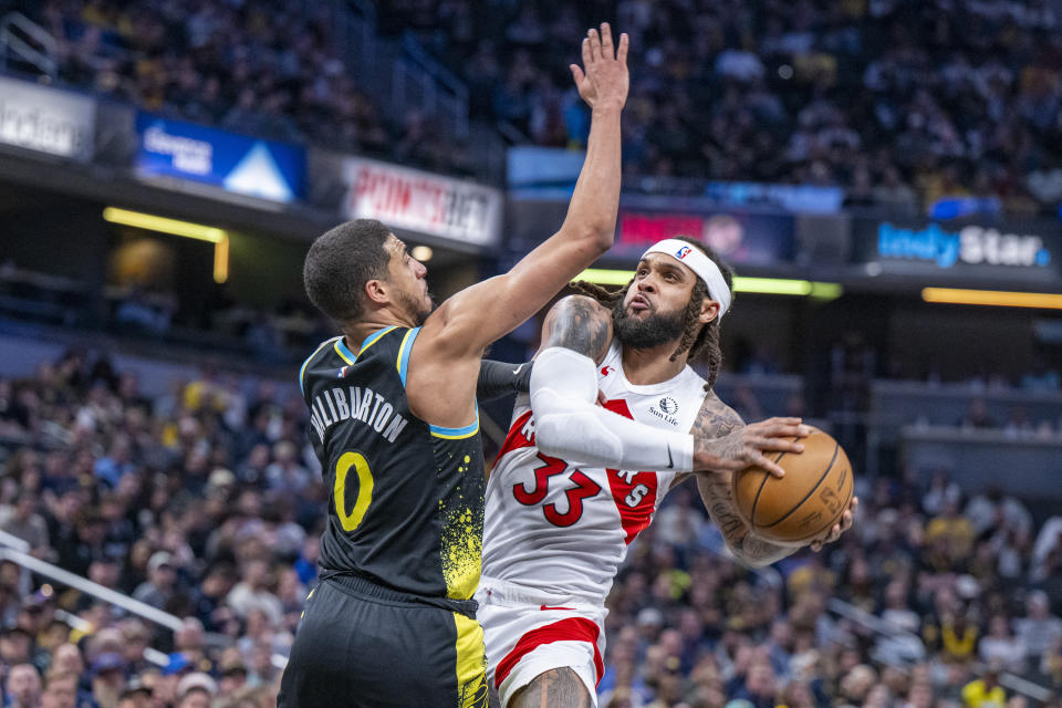 Toronto Raptors guard Gary Trent Jr. (33) shoots while defended by Indiana Pacers guard Tyrese Haliburton (0) during the second half of an NBA basketball game in Indianapolis, Monday, Feb. 26, 2024. (AP Photo/Doug McSchooler)