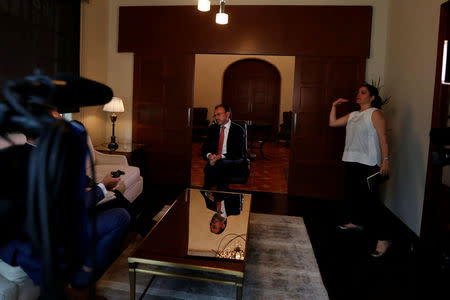 Mexico's Foreign Minister Luis Videgaray (C), speaks during an interview with Reuters as Media Relations Manager for the Ministry of Foreign Affairs Claudia Algorry gestures in Mexico City, Mexico September 15, 2017. REUTERS/Carlos Jasso