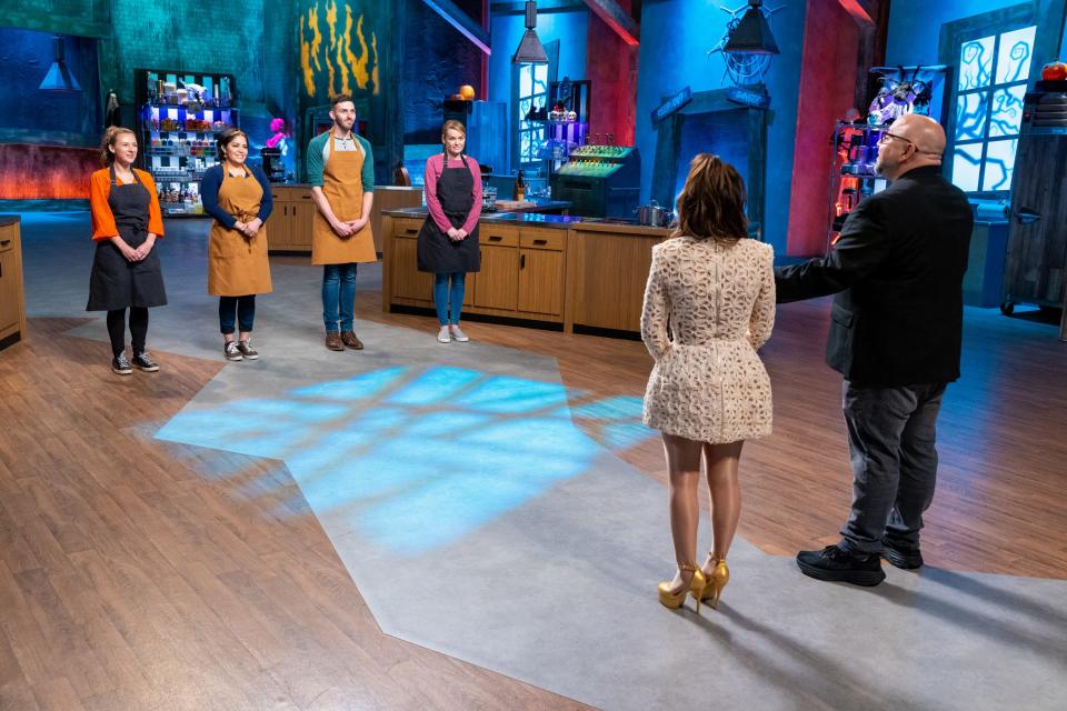 From left, contestants Gabriela Flatt, Naomi Gil, Alex Copeland and Aisling O'Sullivan brace for the results from round 1 delivered by Hosts Rosanna Pansino and Duff Goldman, as seen on season two of "Halloween Cookie Challenge."