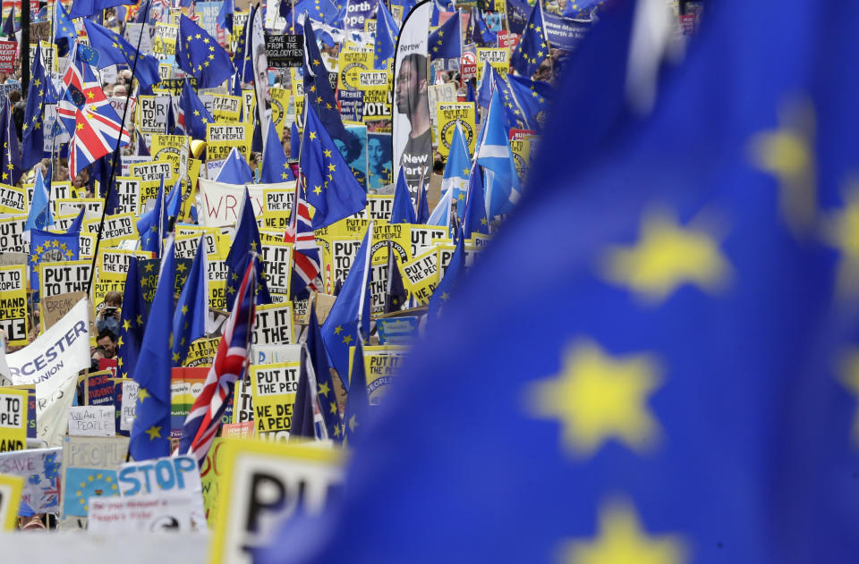 Demonstrators carry posters and flags during a Peoples Vote anti-Brexit march in London, Saturday, March 23, 2019. The march, organized by the People's Vote campaign is calling for a final vote on any proposed Brexit deal. This week the EU has granted Britain's Prime Minister Theresa May a delay to the Brexit process. (AP Photo/Tim Ireland)