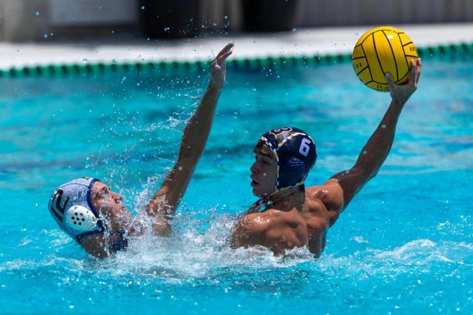 Belen attacker Jack Costello (6) shoots over St. Thomas Aquinas defender Tony Vlasic (12) during the 2023 Boy’s State Championship at Belen Gian Zumpano Aquatic Center in Miami, Florida, on Saturday, April 15, 2023.