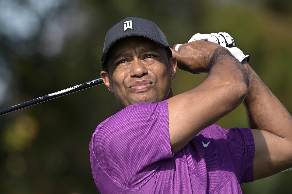 FILE - Tiger Woods watches his tee shot on the first hole during the first round of the PNC Championship golf tournament in Orlando, Fla., in this Dec. 19, 2020, file photo. Woods was injured Tuesday, Feb. 23, 2021, in a vehicle rollover in Los Angeles County and had to be extricated from the vehicle with the “jaws of life” tools, the Los Angeles County Sheriff’s Department said.(AP Photo/Phelan M. Ebenhack, File)