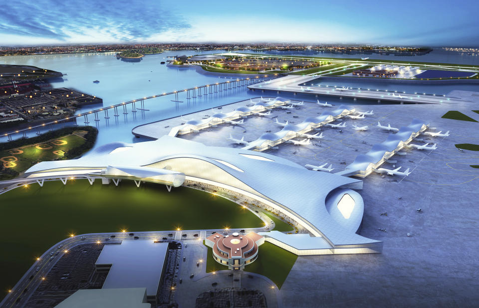 This artist rendering provided by FXFOWLE Architects shows the historic Marine Air Terminal Building, foreground, at New York's LaGuardia Airport, and a proposed plan for connecting it to a new airport runway and terminal, center top on that would be built on the island that now houses the city's massive Rikers Island jail complex. A commission urging the city to close the jail complex proposed reusing the space to expand the airport, which last year had by far the highest rate of late-arriving flights of any of the nation's 29 biggest airports. (FXFOWLE Architects via AP)