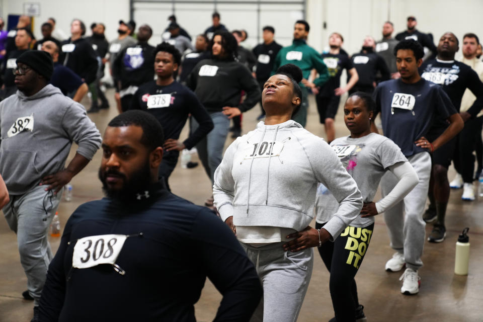 Philadelphia Police Academy applicants warm up before the physical fitness entry exam in Philadelphia, Saturday, Feb. 24, 2024. The city has moved to lower requirements for the entry physical exam at its police academy as part of a broader effort nationally to reevaluate policies that keep law enforcement applicants out of the job pool amid a hiring crisis. (AP Photo/Matt Rourke)